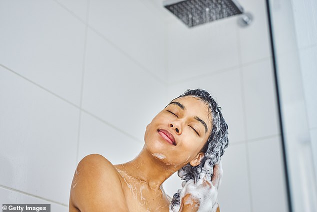 According to experts, hair care ingredients end up on pillowcases and contaminate sheets and towels, which can cause acne (stock image)