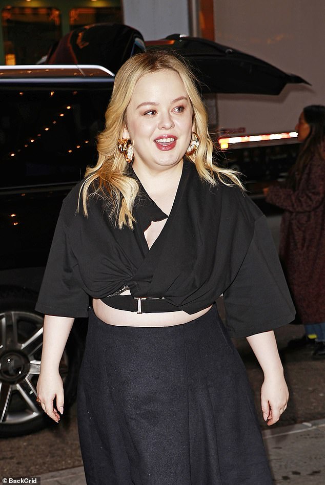 The Bridgerton star teased a glimpse of her stunning figure in a quirky black crop top with pleated details and a plunging neckline