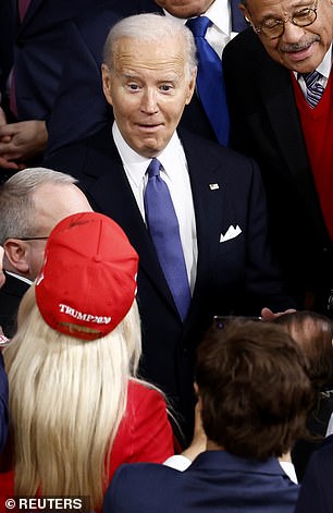 US President Joe Biden reacts as he looks at US Representative Marjorie Taylor Greene (R-GA).