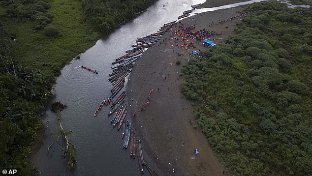 Migrants heading north take boats in Bajo Chiquito in Panama's Darien Province in 2023