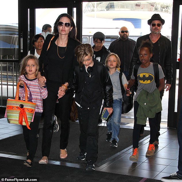 Jolie.  pictured with Pitt and their six children, claims her husband physically and emotionally abused her before the alleged argument broke out on the plane