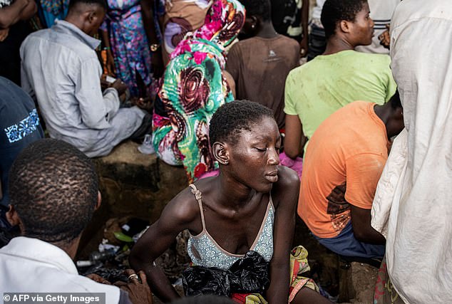 Pictured: A woman sleeping while in a Kush drug den in Freetown, in July 2023