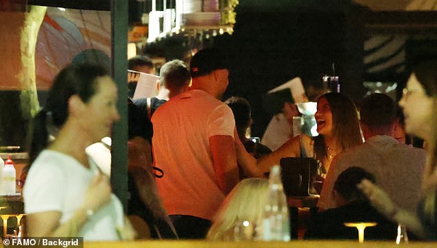 Lauren was seen extending her hand to greet her friend as they laughed together on the night out