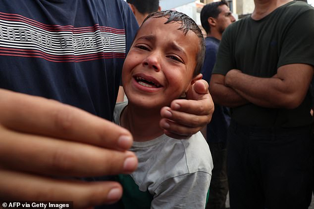 Palestinian child cries as victims of an Israeli bombardment arrive at al-Najjar hospital in Rafah in the southern Gaza Strip on April 1, 2024