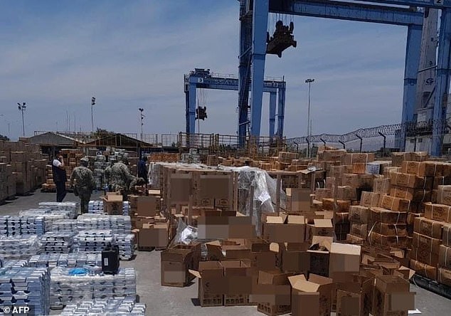 Mexican Navy shows boxes of liquid meth hidden in bottles of tequila seized at the port of Manzanillo