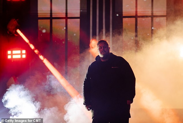 Another shows the fan favorite standing on stage with smoke machines and red and white lights creating a mystical feel