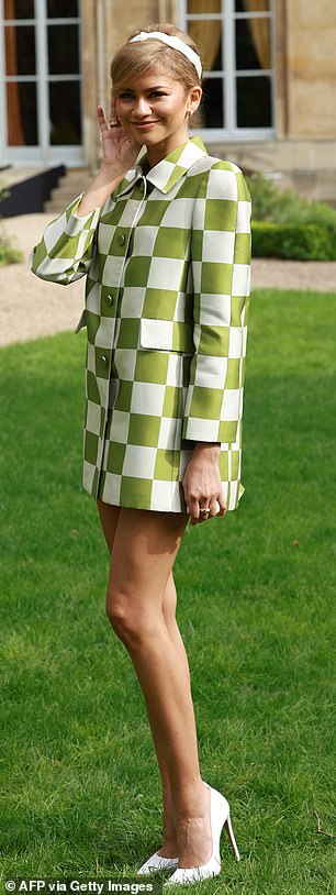 after putting on a leggy display in a white and green checked jacket, she attends the photocall for the new film