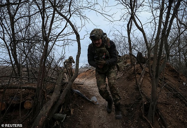 Soldiers of the 12th Special Forces Brigade Azov of the National Guard of Ukraine run to their positions on the front line.  Ukraine claims there have been 626 gas-related attacks by Russia since the outbreak of war