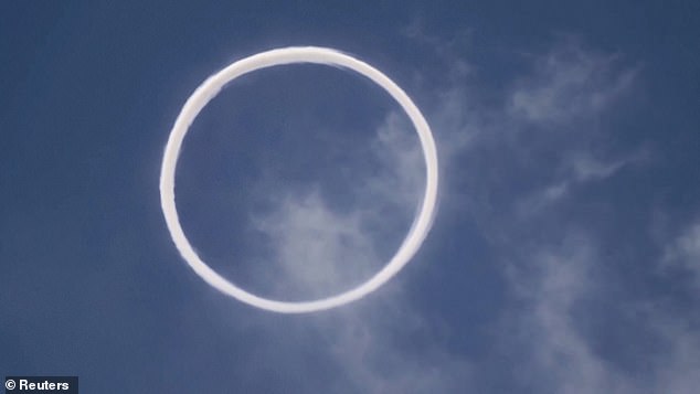 A perfectly circular volcanic smoke ring blown by Mount Etna in the town of Bronte in Sicily, Italy