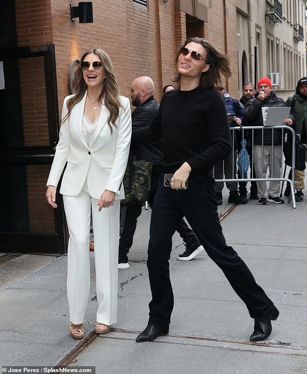 Damian, 22, wore a black top and matching trousers, with a pair of black shoes and sunglasses