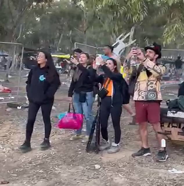 Astar pictured left wearing a black hoodie with a blue logo and leggings at Nova Festival when the rocket fire started