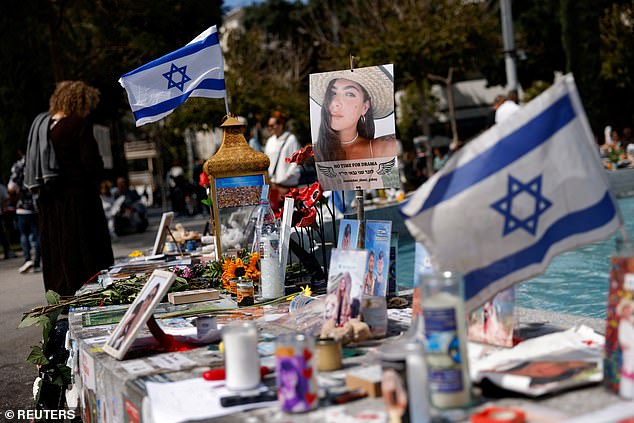 Faced with this existential threat, the Jewish homeland has had no alternative but to defend itself.  Pictured: A member of the public looks at photos of hostages kidnapped in Israel on October 7