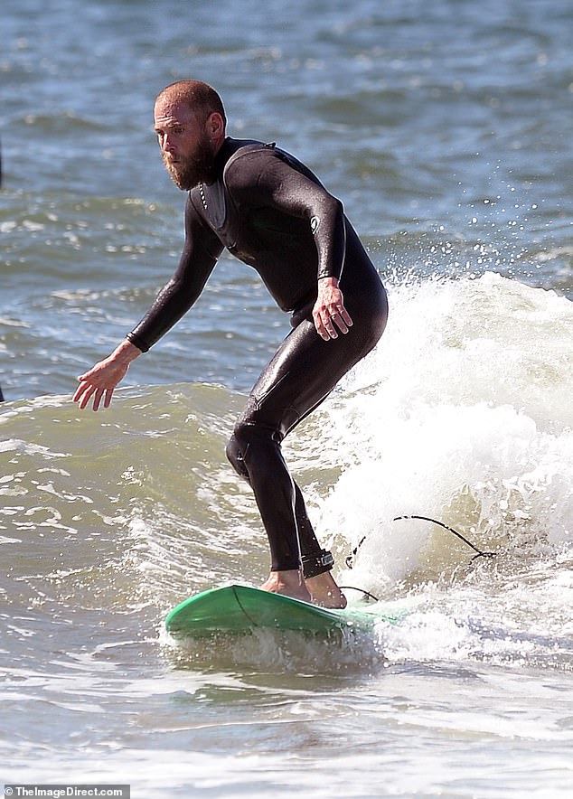 The mid-nineties writer and director looked tanned, with close-cropped hair and a long, scruffy beard, and put his impressive surfing skills on full display.