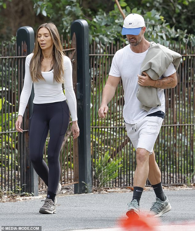 The former WAG and her husband locked lips during the game, oblivious to their surroundings