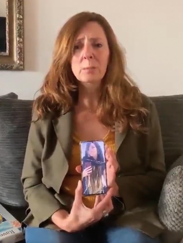 Ricarda Louk, 53, holds up a photo of her daughter before she was brutally murdered during the October 7 Hamas attacks