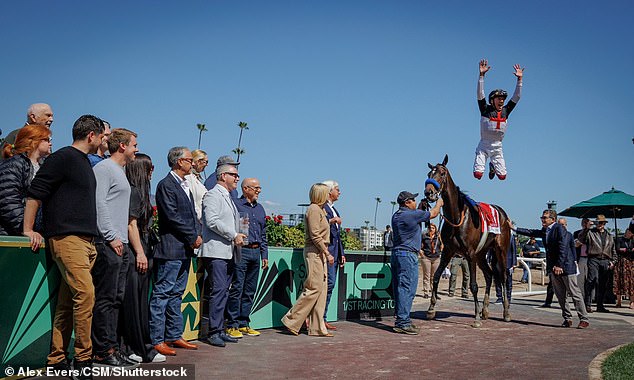 Dettori does his famous jump from Nothing Like You after winning on the 10-1 horse