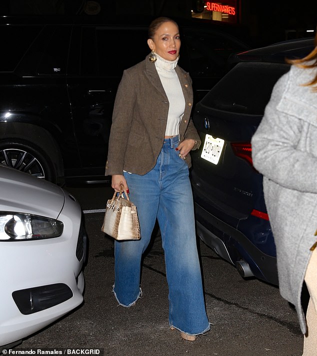 The hitmaker, 54, offered a glimpse of her toned stomach, wearing a cream cropped turtleneck with high-waisted jeans featuring a wide leg and a frayed hem.  She added a brown and black tweed jacket, which complemented the warm tones in her skin tone