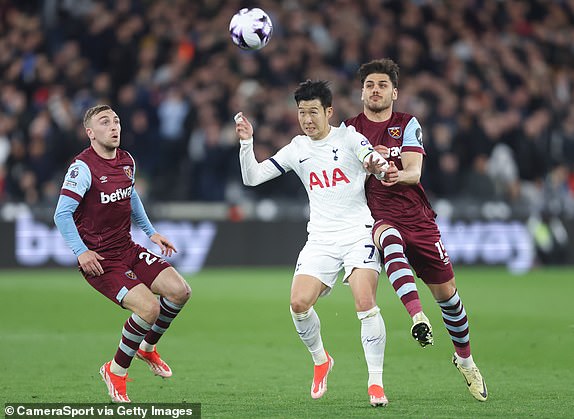 LONDON, ENGLAND - APRIL 2: Son Heung-Min of Tottenham Hotspur is challenged by Konstantinos Mavropanos and Jarrod Bowen of West Ham United during the Premier League match between West Ham United and Tottenham Hotspur at the London Stadium on April 2, 2024 in London, England.  Photo by Rob Newell - CameraSport via Getty Images)