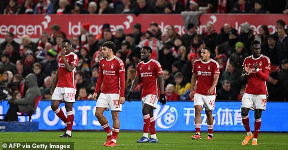 Forest players react to conceding the first goal during the English Premier League football match between Nottingham Forest and Tottenham Hotspur at The City Ground in Nottingham, central England, on December 15, 2023. (Photo by Oli SCARFF / AFP) / LIMITED TO EDITORIAL USE .  No use of unauthorized audio, video, data, fixtures, club/league logos or 'live' services.  Online use during competitions limited to 120 images.  An additional 40 images can be used in the additional time.  No video emulation.  Use of social media during competitions is limited to 120 images.  An additional 40 images can be used in the additional time.  No use in betting, competition or individual club/competition/player publications.  / (Photo by OLI SCARFF/AFP via Getty Images)