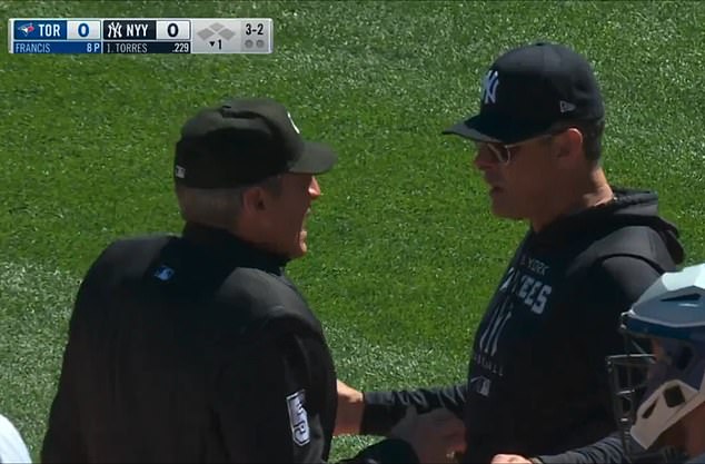 Hernandez (L) discusses the out with New York Yankees manager Aaron Boone