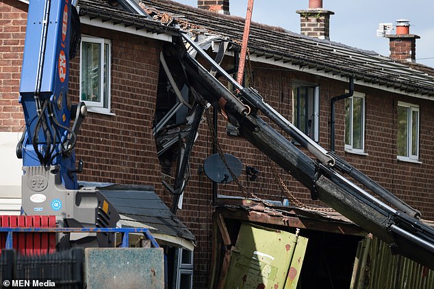 The crane 'cut through' the building.  The incident happened at a property in Atherton, Wigan, Lancashire