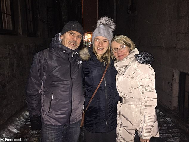 Her husband Robert, 59, (left) was driving the pickup truck and pulling the caravan in which Dr. Woroniecka (right) was driving.  They are pictured with one of their daughters who may have been with them on the journey.