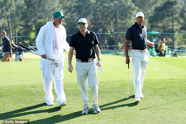 Woods was accompanied by caddy Lance Bennett (L) and business partner Rob McNamara