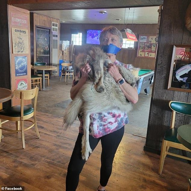 Jeanne Ivie-Roberts, a close relative of Roberts who lives in Daniel, reenacted the strange scene with a wolf skin in the same bar - including taping up her mouth.