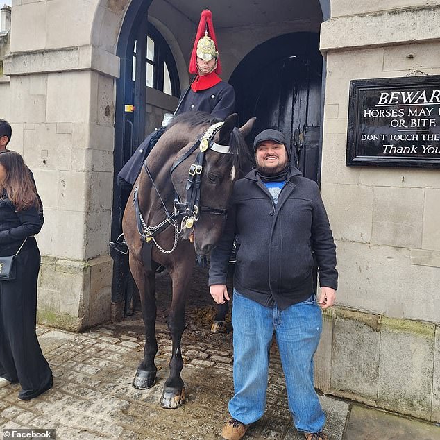 James Wolfe, 40, was shot during an argument where Mei allegedly told him she wanted him out of the house.  He had recently moved in with them after graduating from university and traveling, where he posed here with a King's Guardsman in London.