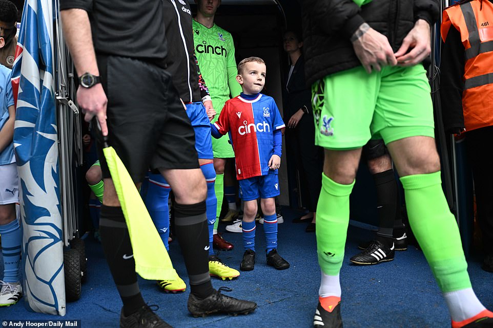 A young mascot held hands with Palace captain Joel Ward before walking out of the tunnel alongside both teams