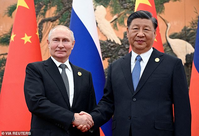 Russian President Vladimir Putin shakes hands with Chinese President Xi Jinping during a meeting at the Belt and Road Forum in Beijing, China, October 18, 2023. Moscow and Beijing declared a 'no borders' partnership in February 2022 when Putin spent several days previously visited Beijing.  Russia launched its full-scale invasion of Ukraine