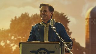 Hank MacLean gives a speech on a stage in Amazon's Fallout TV series