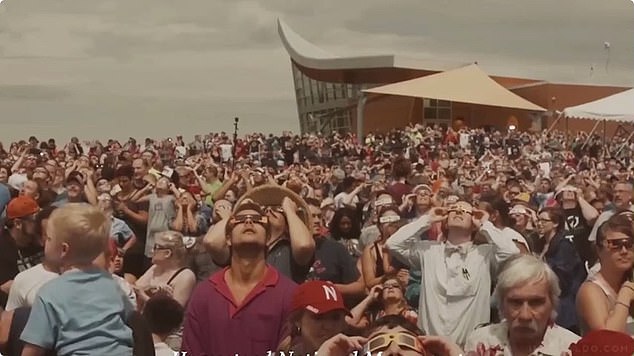 With the 2001: A Space Odyssey theme playing in the background, the video then cuts to photos of crowds gathering to watch the solar eclipse with their glasses on.