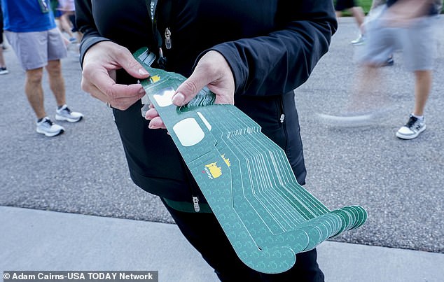 During a practice round in Augusta, Eclipse glasses are handed out to customers at the entrance