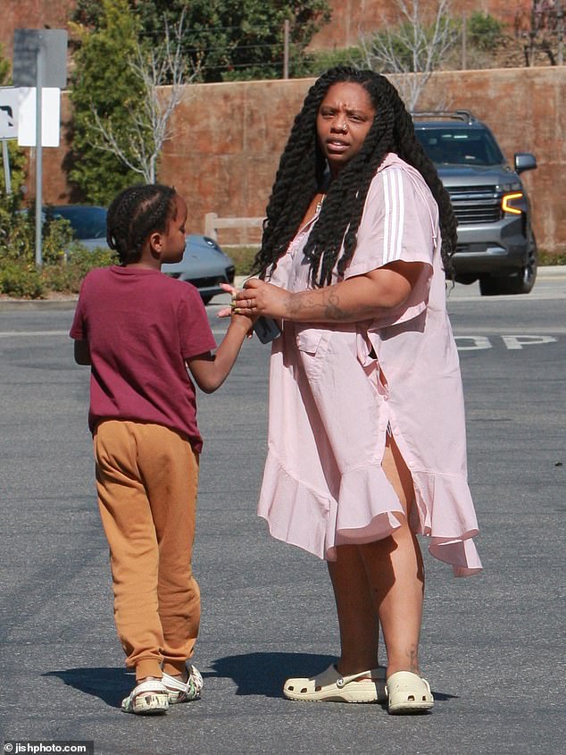 Cullors, who was accompanied by her son, was makeup-free and dressed in a shapeless pink Adidas poncho and Crocs