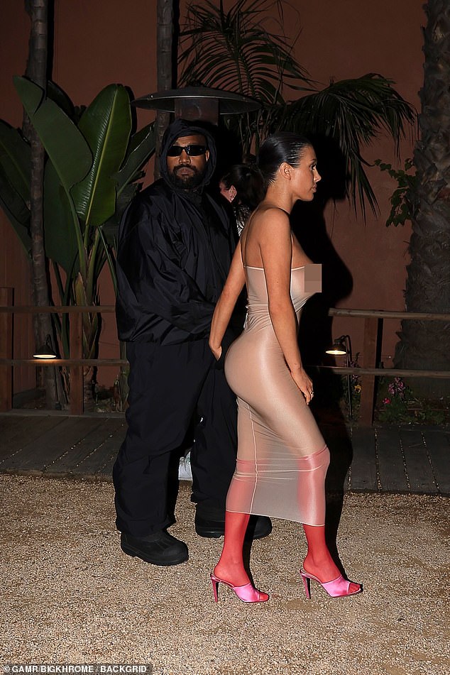 Kanye West's wife also showed off a side view of her racing ensemble, highlighting her shapely derriere