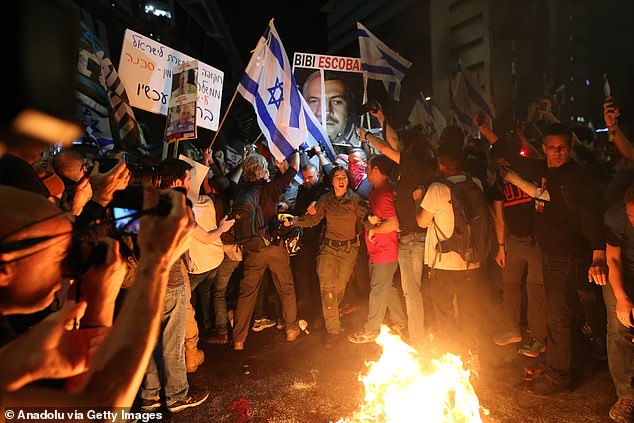 Protesters light a fire on Tel Aviv's Kaplan Street