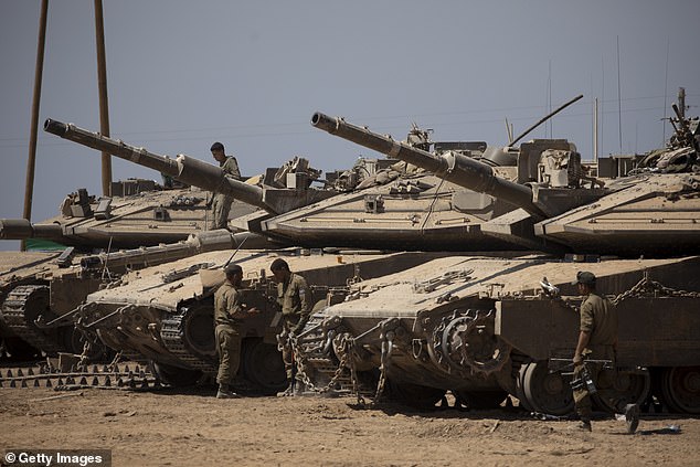 Israeli soldiers organize their refueling equipment near the Gaza Strip border