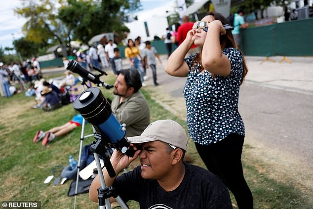 People gather as they prepare to observe the beginning of the solar eclipse in Torreon, Mexico