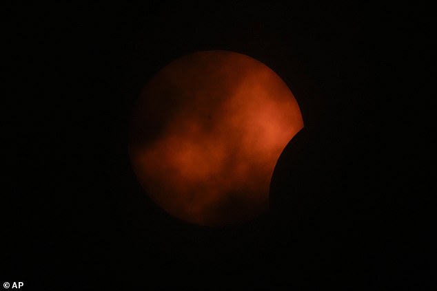 ARLINGTON, TEXAS: Clouds move through the atmosphere limiting visibility of the partial total solar eclipse