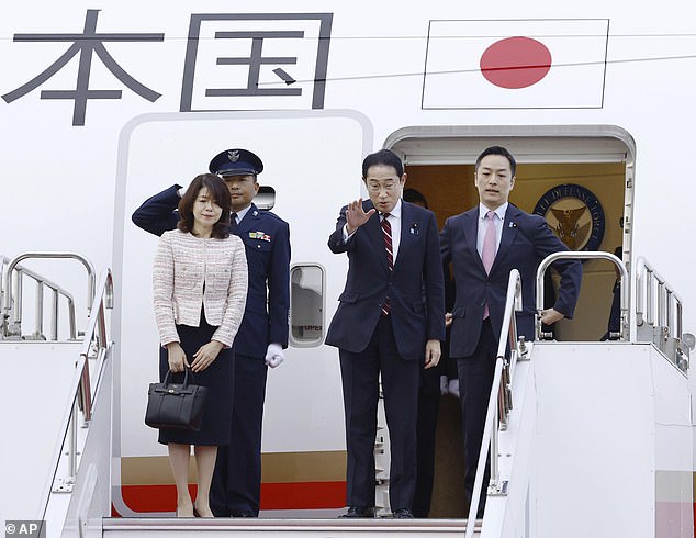 Japanese Prime Minister Fumio Kishida, center, waves, with his wife Yuko, leaving Tokyo's Haneda Airport on Monday as they departed for the US