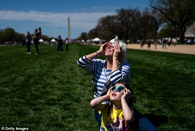 Americans also headed to the nearby National Mall to watch the rare event