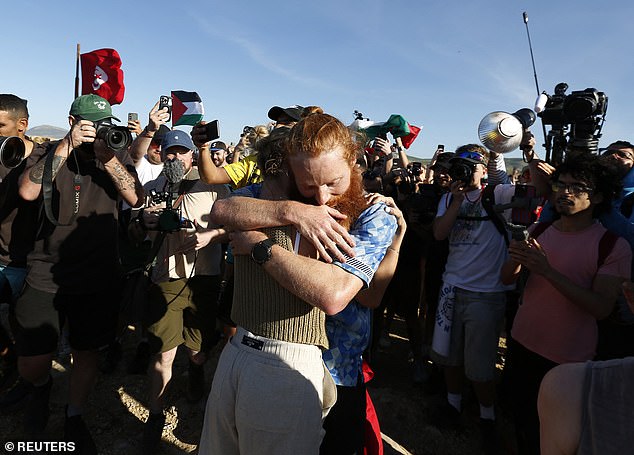 Cook hugs his supporters at the finish line after completing 385 marathons in a year