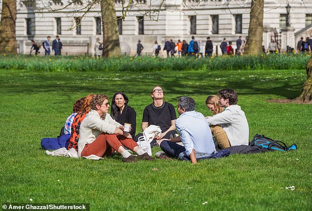 People enjoy the spring sunshine in St James's Park London as temperatures are expected to reach 17 degrees Celsius on March 20, 2024