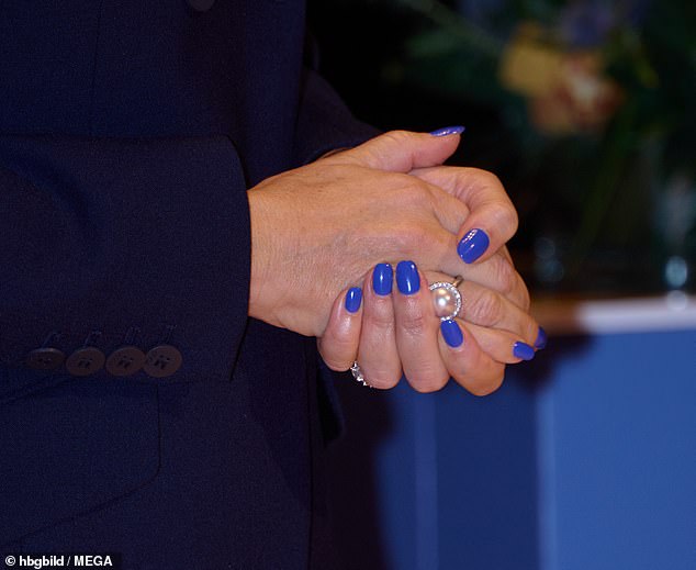 The bright color caught the attention of the monarch's style watchers with one saying: 'Funky nails from the newly minted Queen Mary'