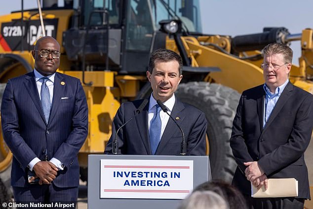 Malinowski is seen here at right next to Pete Buttigieg, the Secretary of Transportation, during a visit to Clinton National Airport last March