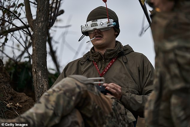 A Ukrainian military pilot of an FPV drone during a combat flight with an accumulative payload on the front line near Bakhmut