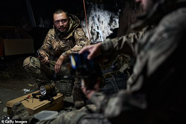 A Ukrainian military pilot of an FPV drone while attaching an explosive to an FPV drone on the front line near Bakhmut on October 24, 2023 in Bakhmut