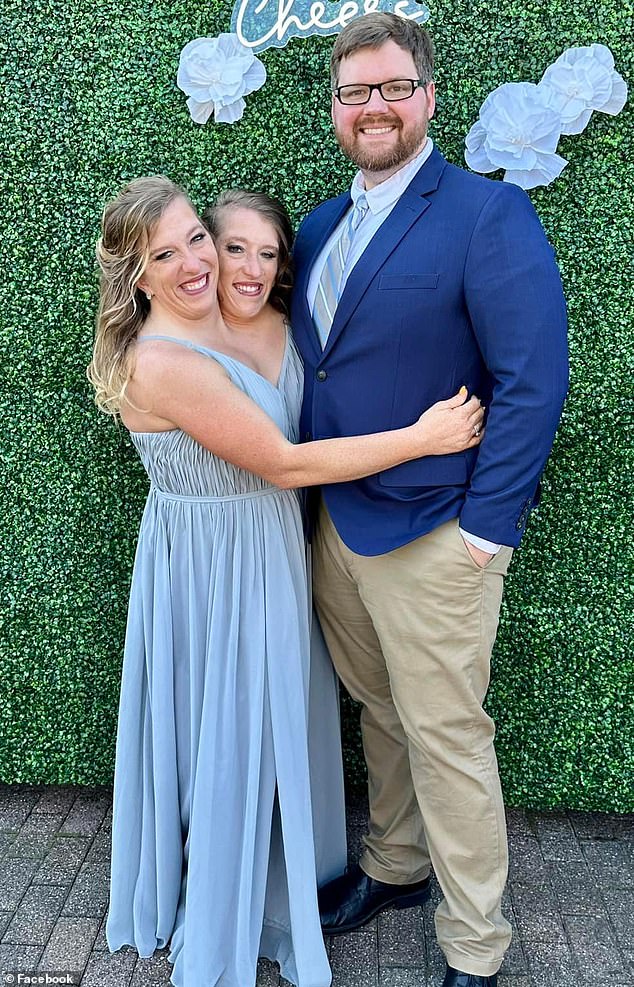 Conjoined twins Abby Hensel (left) and Brittany (center) are one of the few sets of dicephalus twins in history to survive infancy.  They are pictured with Abby's husband Josh Bowling (right)