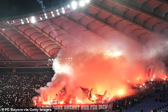 ROME, ITALY - FEBRUARY 14: Bayern Munich fans show their support as they wave flags and light pyrotechnics ahead of the kick-off for the UEFA Champions League 2023/24 Round of 16 first leg between SS Lazio and FC Bayern Munich at Stadio Olimpico on February 14, 2024 in Rome, Italy.  (Photo by S. Mellar/FC Bayern via Getty Images)